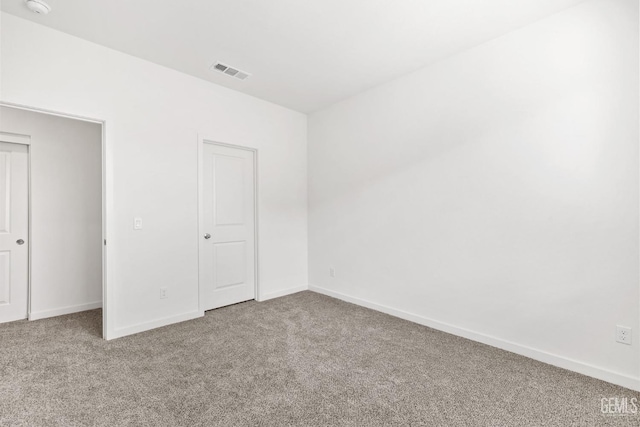 unfurnished bedroom featuring carpet flooring, baseboards, and visible vents