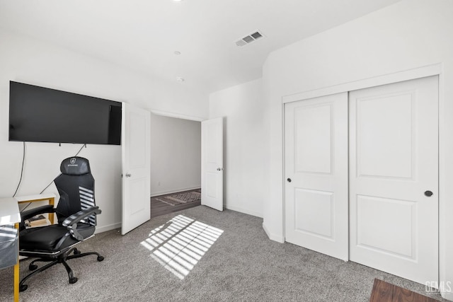 carpeted office featuring baseboards and visible vents