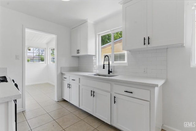 2804 Haley St, Bakersfield, CA 93305 - kitchen with a sink, tasteful backsplash, light countertops, white cabinets, and vaulted ceiling
