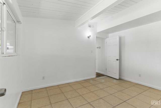2804 Haley St, Bakersfield, CA 93305 - empty room with beamed ceiling, wooden ceiling, light tile patterned floors, and baseboards