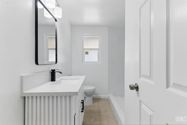 2804 Haley St, Bakersfield, CA 93305 - full bathroom with toilet, tile patterned flooring, vanity, a shower, and baseboards
