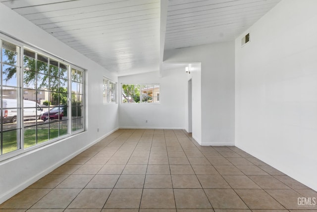 2804 Haley St, Bakersfield, CA 93305 - empty room featuring vaulted ceiling, light tile patterned flooring, and baseboards