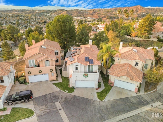 birds eye view of property with a mountain view