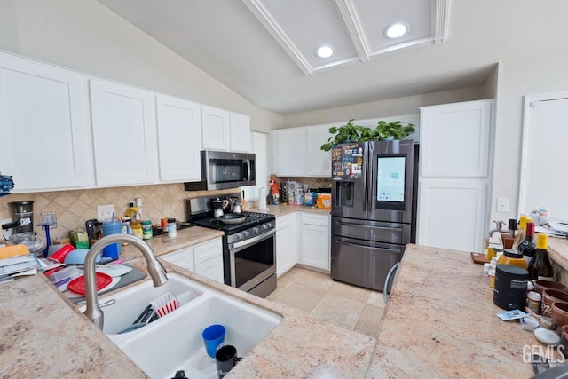 7519 Shadow Wells St, Bakersfield, CA 93313 - kitchen featuring stainless steel appliances, tasteful backsplash, white cabinetry, lofted ceiling, and recessed lighting