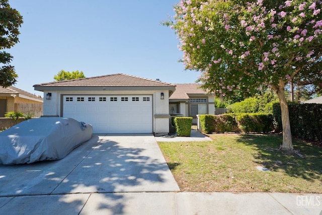 7519 Shadow Wells St, Bakersfield, CA 93313 - ranch-style house with concrete driveway, stucco siding, a tile roof, and a garage