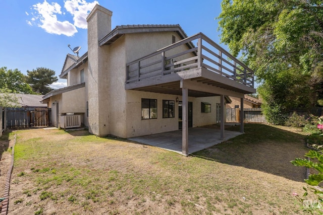 1224 N Mayflower Cir, Ridgecrest, CA 93555 - back of property with a fenced backyard, a patio, stucco siding, and a yard