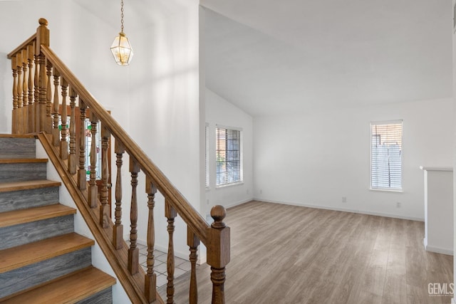 1224 N Mayflower Cir, Ridgecrest, CA 93555 - staircase featuring lofted ceiling, a wealth of natural light, baseboards, and wood finished floors