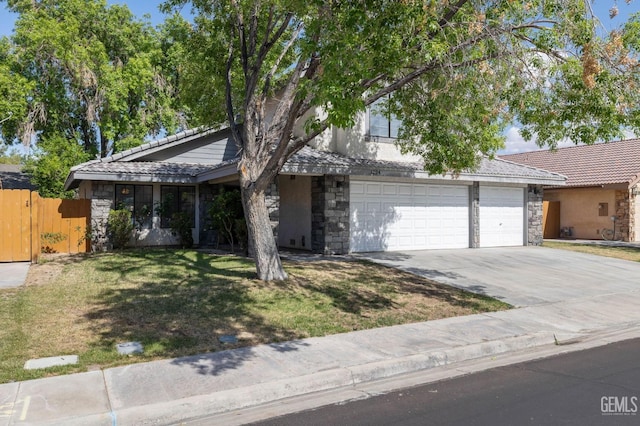 1224 N Mayflower Cir, Ridgecrest, CA 93555 - view of front of property with fence, a tiled roof, stone siding, and concrete driveway