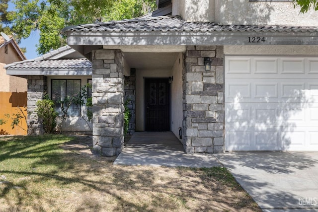 1224 N Mayflower Cir, Ridgecrest, CA 93555 - entrance to property featuring stone siding, stucco siding, and a garage