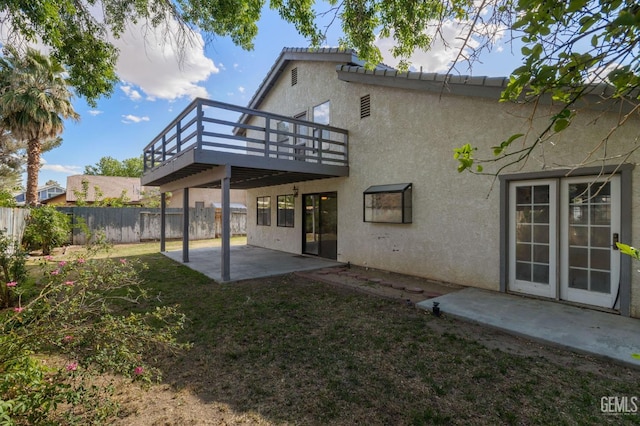 1224 N Mayflower Cir, Ridgecrest, CA 93555 - back of property with a lawn, fence, a patio area, stucco siding, and a deck