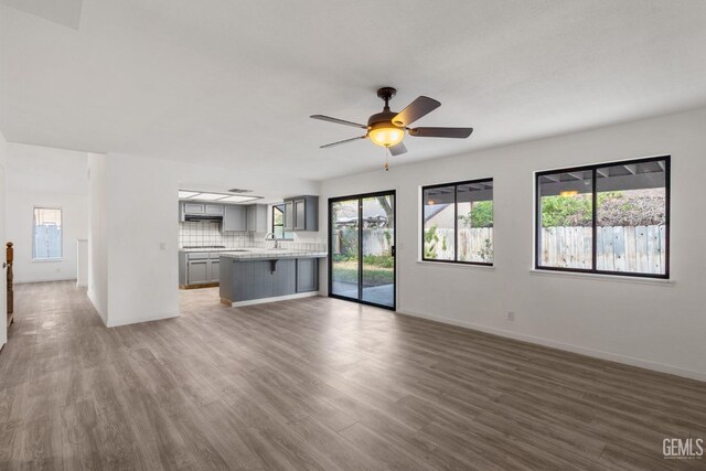 1224 N Mayflower Cir, Ridgecrest, CA 93555 - unfurnished living room with a sink, a healthy amount of sunlight, and wood finished floors