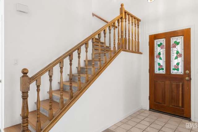 1224 N Mayflower Cir, Ridgecrest, CA 93555 - foyer entrance with tile patterned floors, stairway, and baseboards