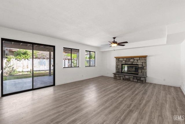 1224 N Mayflower Cir, Ridgecrest, CA 93555 - unfurnished living room featuring a ceiling fan, baseboards, a fireplace, and wood finished floors