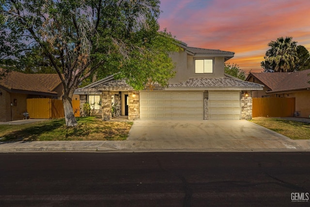 1224 N Mayflower Cir, Ridgecrest, CA 93555 - view of front facade with fence, stucco siding, a tile roof, concrete driveway, and stone siding