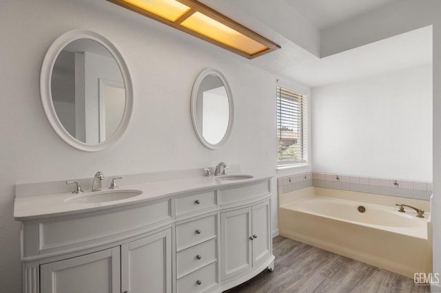 1224 N Mayflower Cir, Ridgecrest, CA 93555 - bathroom with a garden tub, double vanity, a sink, and wood finished floors