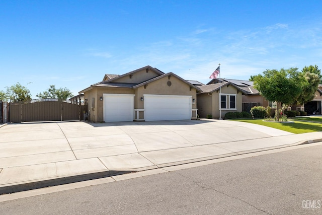 7714 Valle De Baztan Dr, Bakersfield, CA 93314 - ranch-style house featuring a gate, an attached garage, stucco siding, concrete driveway, and roof mounted solar panels