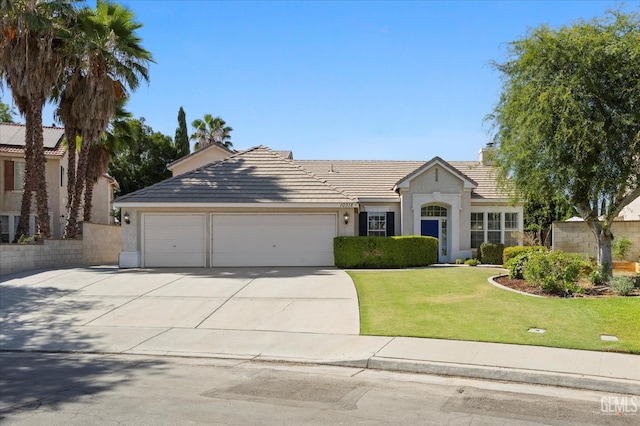 10318 Roehampton Ave, Bakersfield, CA 93312 - view of front of home with concrete driveway, a garage, a tiled roof, a front lawn, and stucco siding