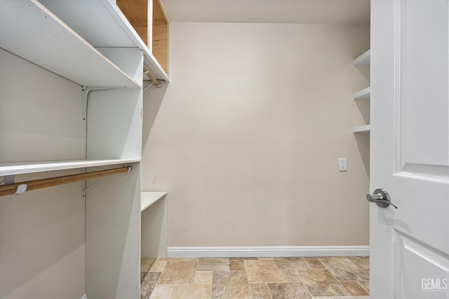 10318 Roehampton Ave, Bakersfield, CA 93312 - walk in closet featuring stone finish flooring