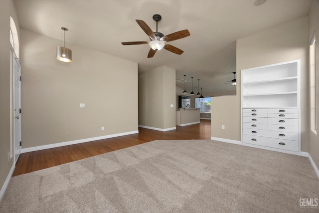 10318 Roehampton Ave, Bakersfield, CA 93312 - unfurnished living room featuring carpet flooring, ceiling fan, and wood finished floors