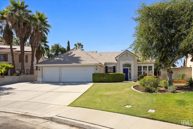 10318 Roehampton Ave, Bakersfield, CA 93312 - view of front facade with an attached garage, stucco siding, concrete driveway, and a tile roof