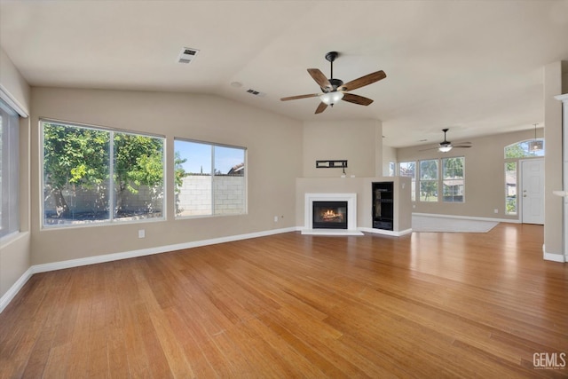 10318 Roehampton Ave, Bakersfield, CA 93312 - unfurnished living room featuring ceiling fan, light wood-style floors, a glass covered fireplace, and lofted ceiling
