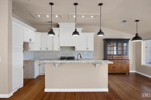 10318 Roehampton Ave, Bakersfield, CA 93312 - kitchen with dark wood finished floors, decorative backsplash, white cabinets, lofted ceiling, and a center island with sink