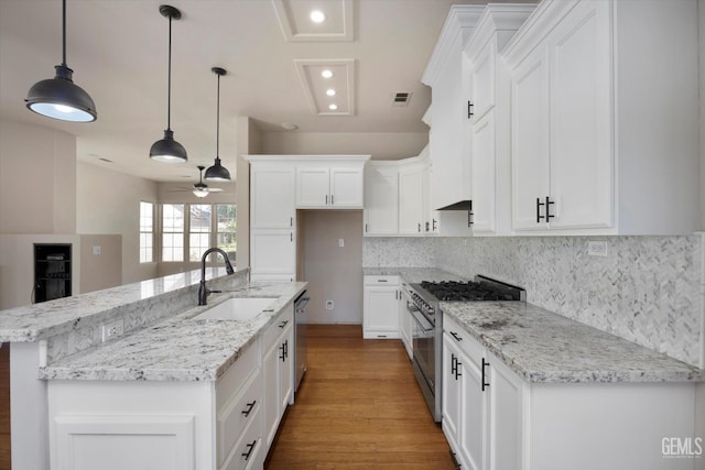 10318 Roehampton Ave, Bakersfield, CA 93312 - kitchen with appliances with stainless steel finishes, a ceiling fan, white cabinets, wood finished floors, and recessed lighting