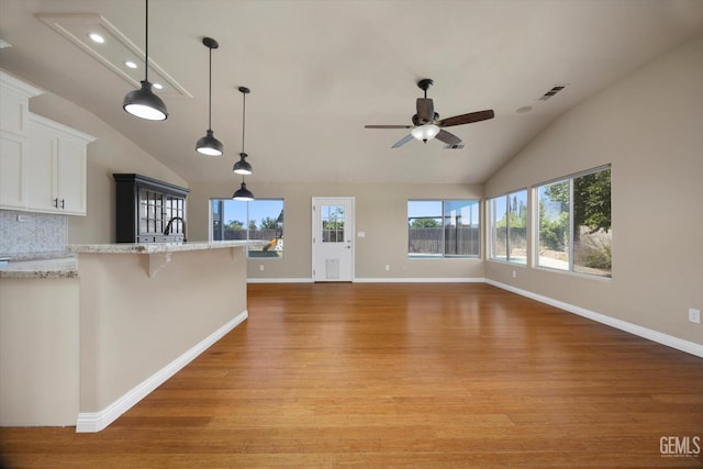 10318 Roehampton Ave, Bakersfield, CA 93312 - unfurnished living room featuring lofted ceiling, plenty of natural light, light wood-style flooring, and a ceiling fan