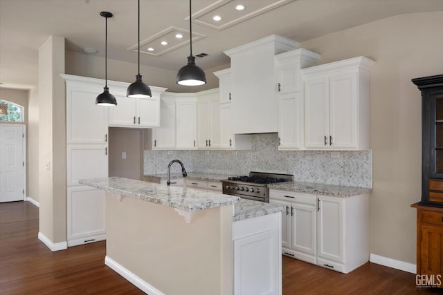 10318 Roehampton Ave, Bakersfield, CA 93312 - kitchen featuring stainless steel gas stove, dark wood-style floors, backsplash, white cabinets, and recessed lighting