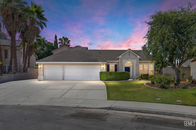 10318 Roehampton Ave, Bakersfield, CA 93312 - ranch-style home with an attached garage, concrete driveway, a tiled roof, stucco siding, and a front yard