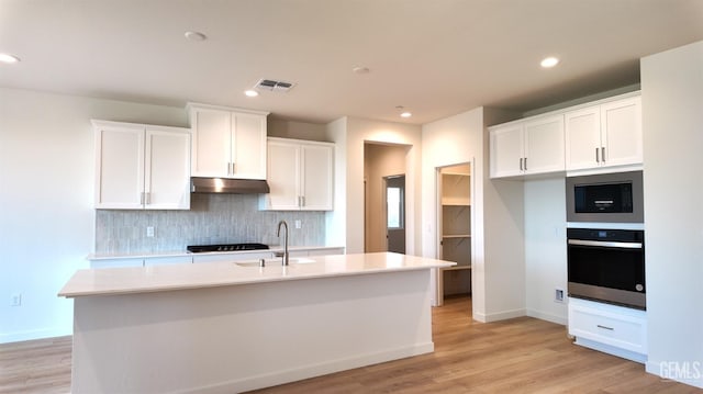 12801 Kinnick Ct, Bakersfield, CA 93311 - kitchen with appliances with stainless steel finishes, backsplash, light wood finished floors, white cabinets, and recessed lighting