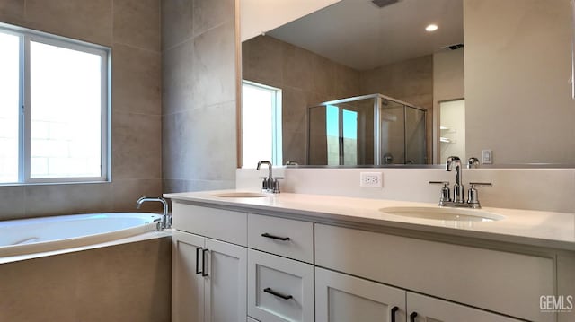 12801 Kinnick Ct, Bakersfield, CA 93311 - full bathroom featuring healthy amount of natural light, a shower stall, double vanity, and a garden tub