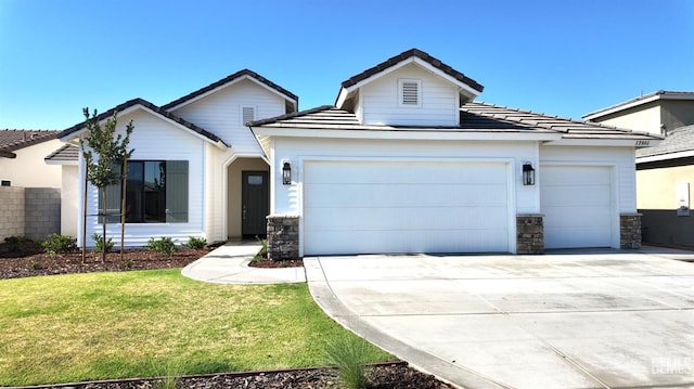 12801 Kinnick Ct, Bakersfield, CA 93311 - view of front of home with an attached garage, stone siding, and driveway