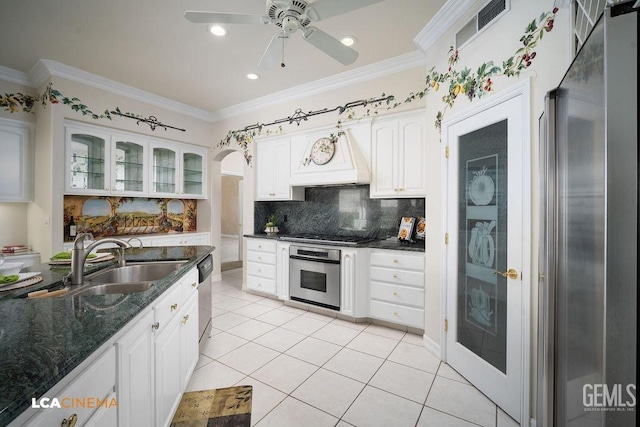 kitchen with appliances with stainless steel finishes, sink, white cabinets, custom exhaust hood, and crown molding