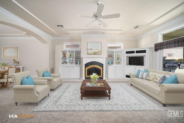 living room with crown molding, ceiling fan, and built in features