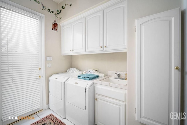 washroom featuring light tile patterned flooring, cabinets, sink, and washing machine and dryer