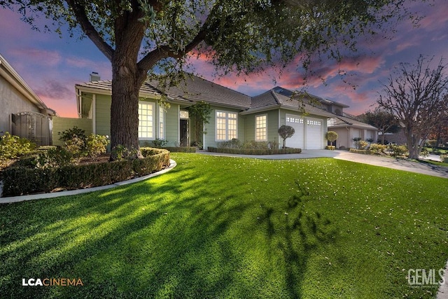 view of front of house with a garage and a yard