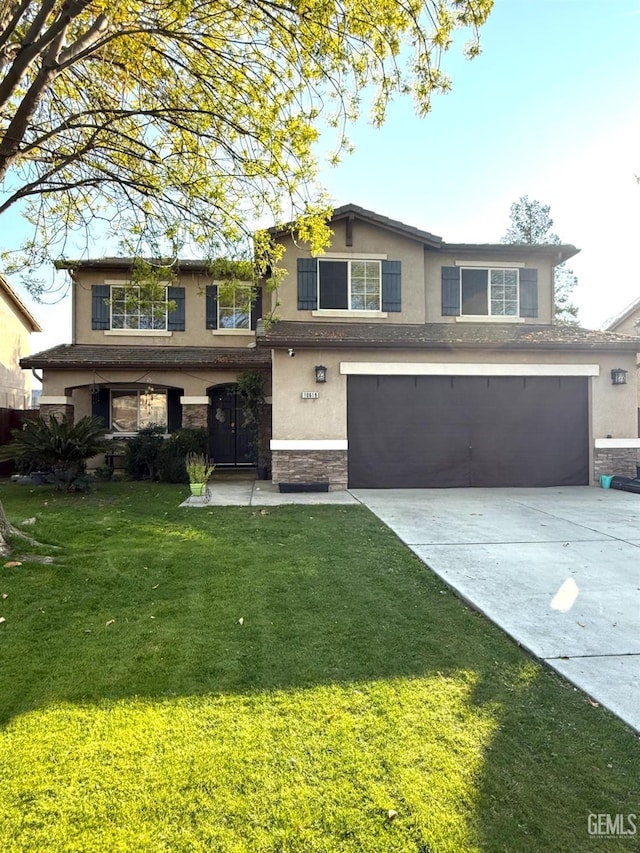 view of property with a garage and a front lawn