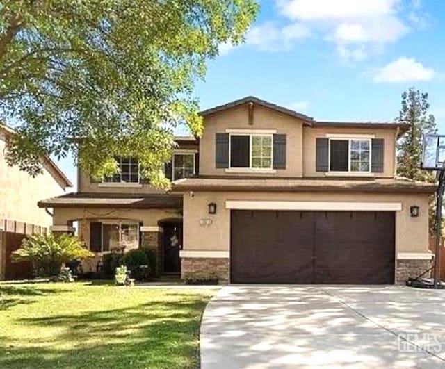 view of front of home with a front yard and a garage