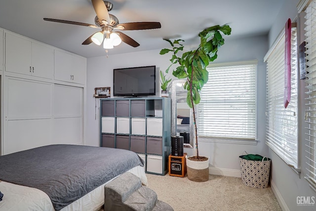 bedroom featuring ceiling fan and baseboards