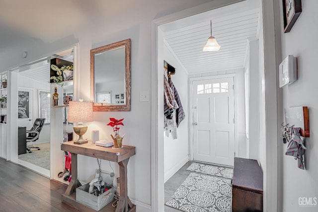 entryway featuring baseboards and wood finished floors