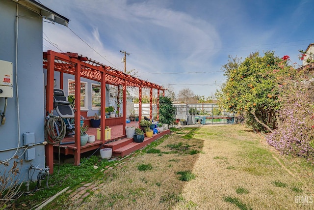 view of yard featuring fence and a pergola