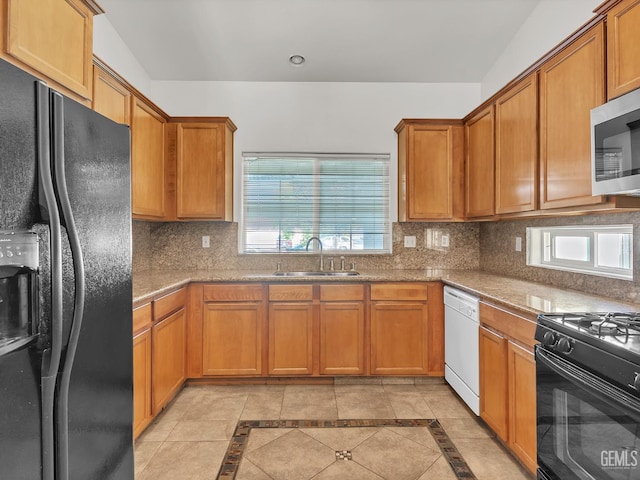 kitchen with black appliances, backsplash, plenty of natural light, and a sink