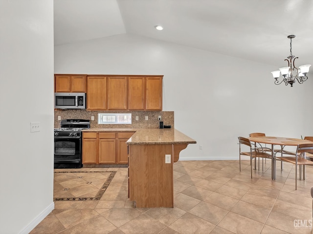 kitchen with stainless steel microwave, tasteful backsplash, black range with gas stovetop, a peninsula, and a notable chandelier