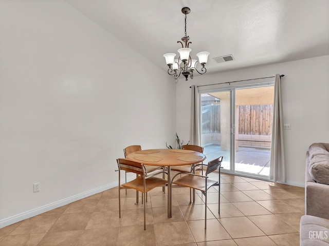 dining space with light tile patterned flooring, a notable chandelier, baseboards, and visible vents
