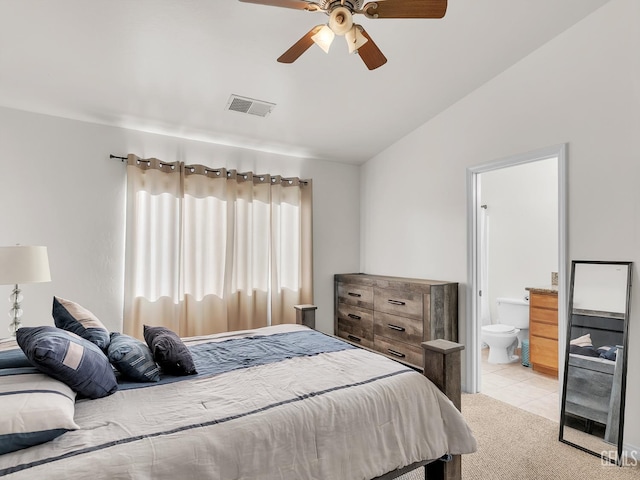 bedroom featuring light tile patterned floors, light carpet, ensuite bathroom, visible vents, and lofted ceiling