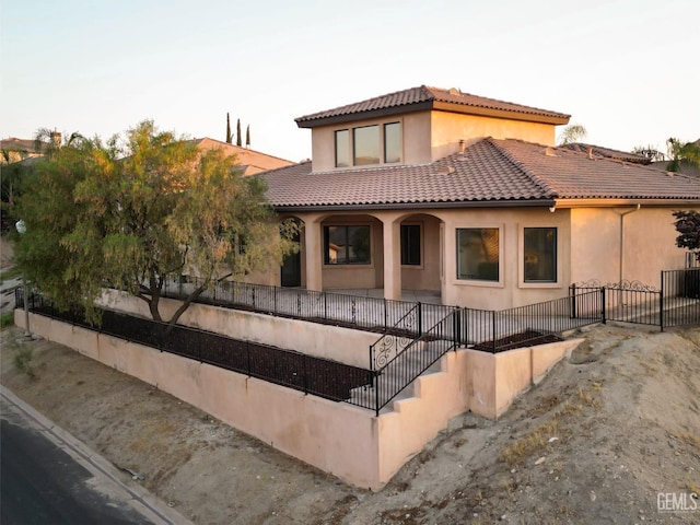 5507 Via Venezia, Bakersfield, CA 93306 - view of front of property with a tile roof, stairway, stucco siding, and fence