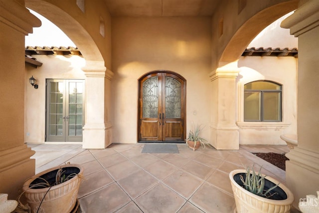 5507 Via Venezia, Bakersfield, CA 93306 - view of exterior entry featuring french doors, a tiled roof, and stucco siding