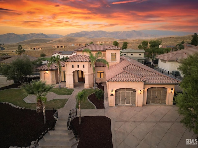 5507 Via Venezia, Bakersfield, CA 93306 - mediterranean / spanish-style house featuring a mountain view, stucco siding, driveway, a garage, and a tile roof