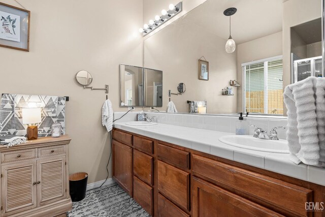 9310 Via Catania, Bakersfield, CA 93312 - full bath with a stall shower, double vanity, a sink, and decorative backsplash